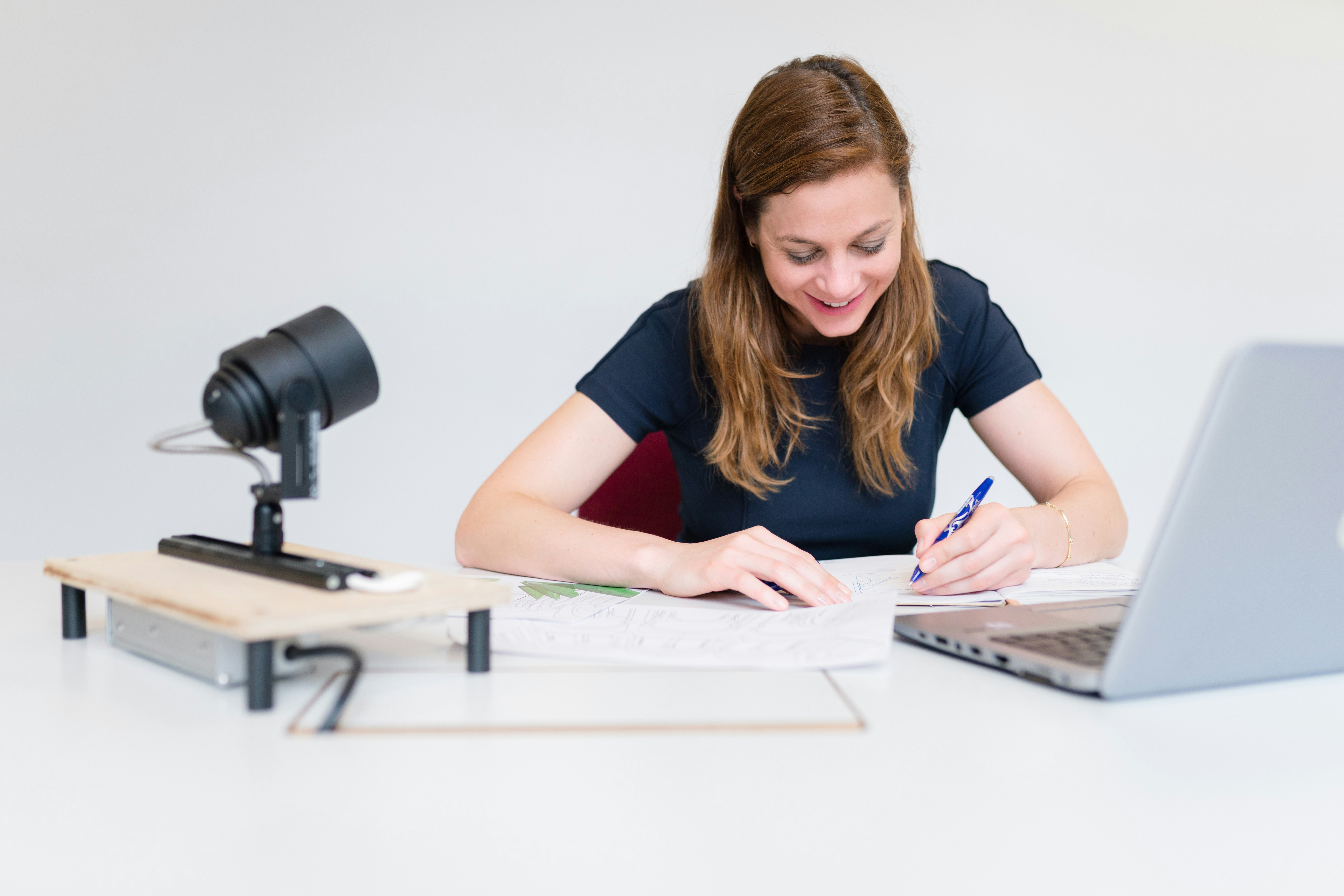 woman writing -  How To Rephrase A Thesis Statement