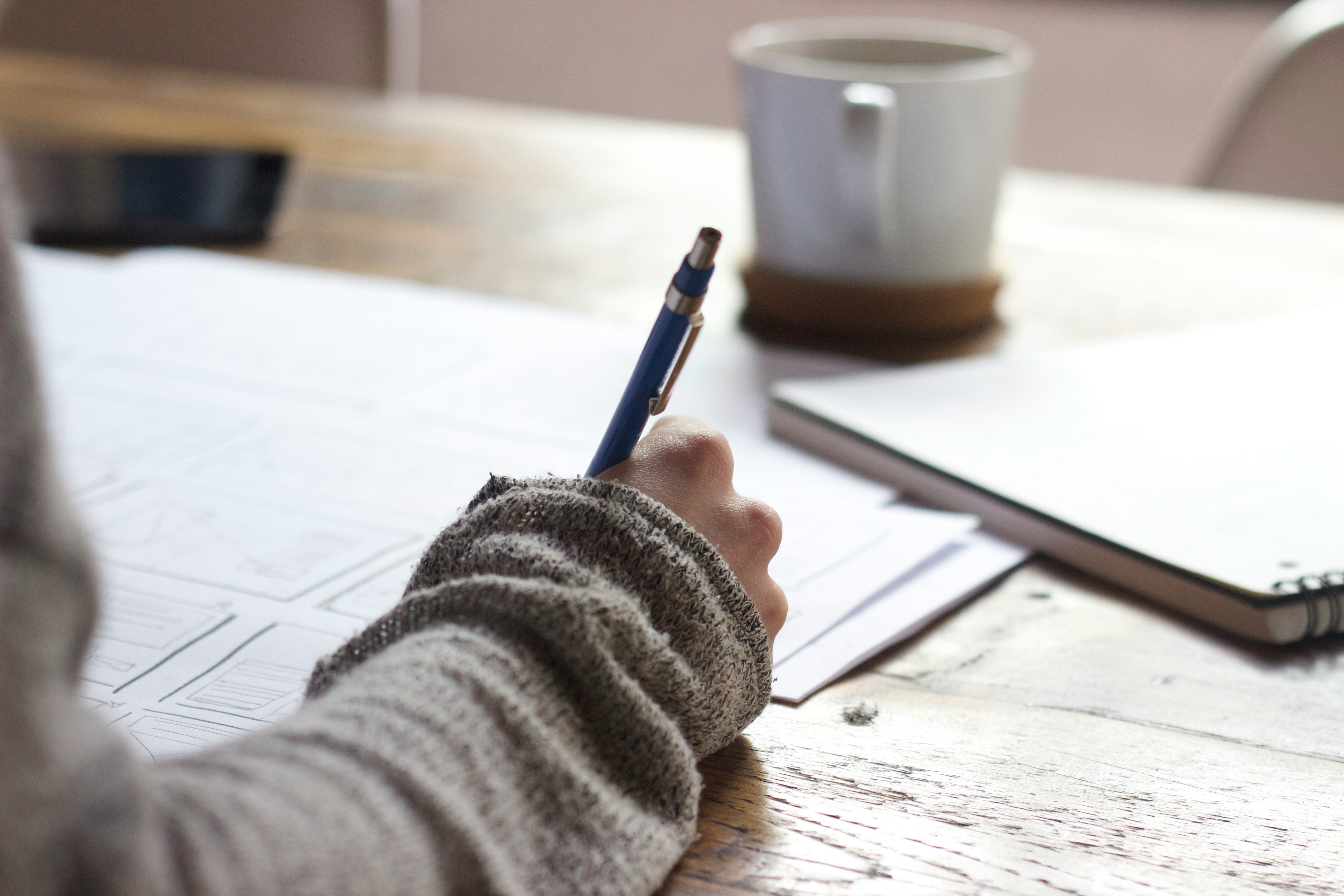 person writing - How To Paraphrase A Paragraph